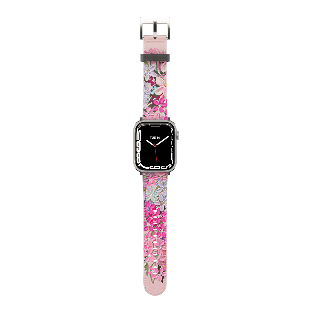 A pink and purple floral-patterned Apple Watch band with a metal buckle clasp.