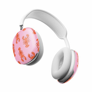 White headphones with pink ear cups featuring lobster pattern on a white background