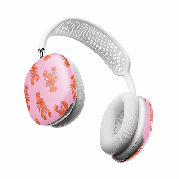 White headphones with pink ear cups featuring lobster pattern on a white background