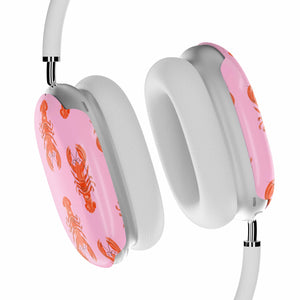 Headphones with pink ear cushions featuring lobster designs on a white background