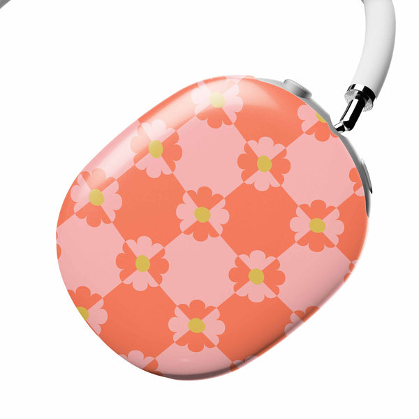 Round pink and orange floral case with a white strap on a white background