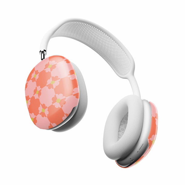 White headphones with floral design on the ear cups against a white background