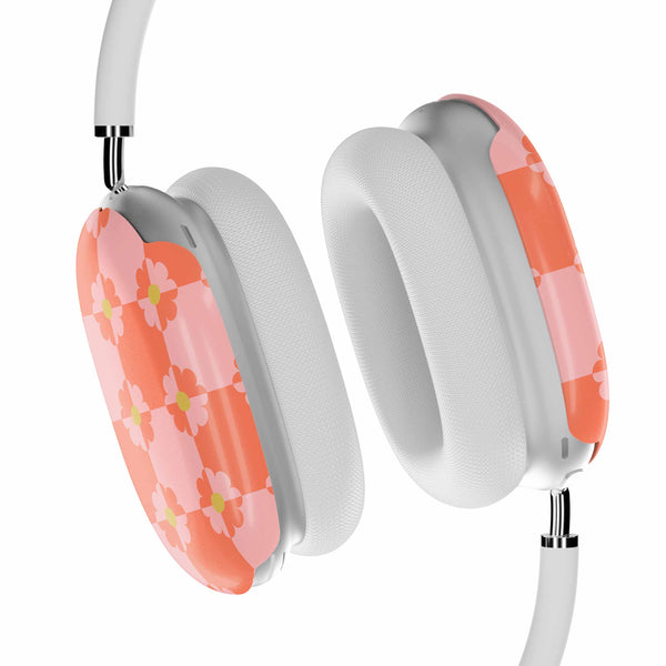 White headphones with pink floral design on a white background