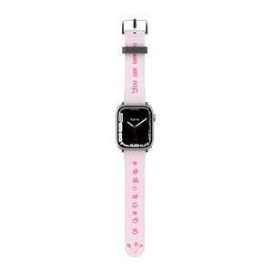 A pink Apple Watch band with white text and design, featuring a digital display on the watch face.