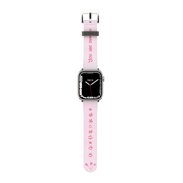 A pink Apple Watch band with white text and design, featuring a digital display on the watch face.