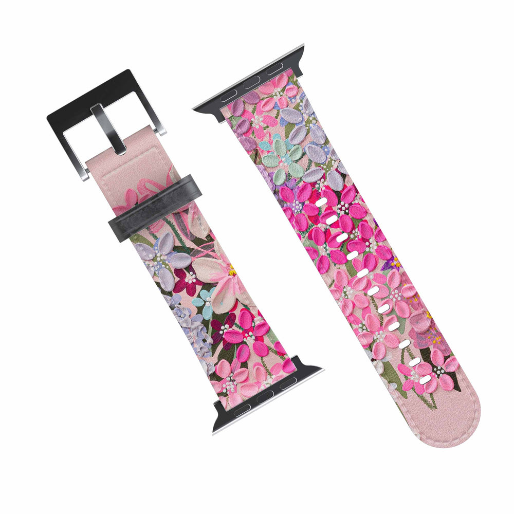 A pink and purple floral-patterned Apple Watch band with a metal buckle clasp.